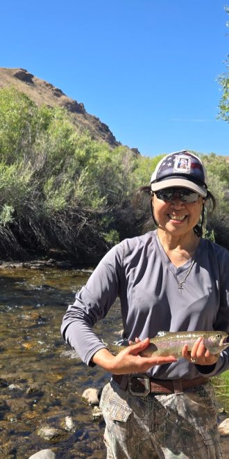 Lady holding rainbow trout