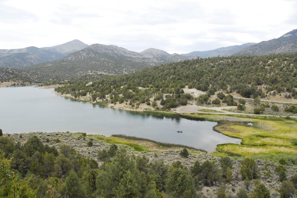 Cave Lake from above with kayak carrying two people in the water